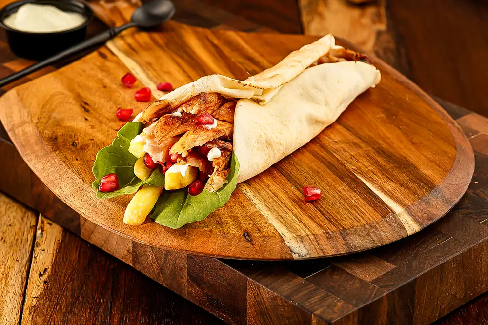 Experience chicken shawarma delights near cedar crest 1 Juicy chicken shawarma wrap with fresh toppings near cedar crest